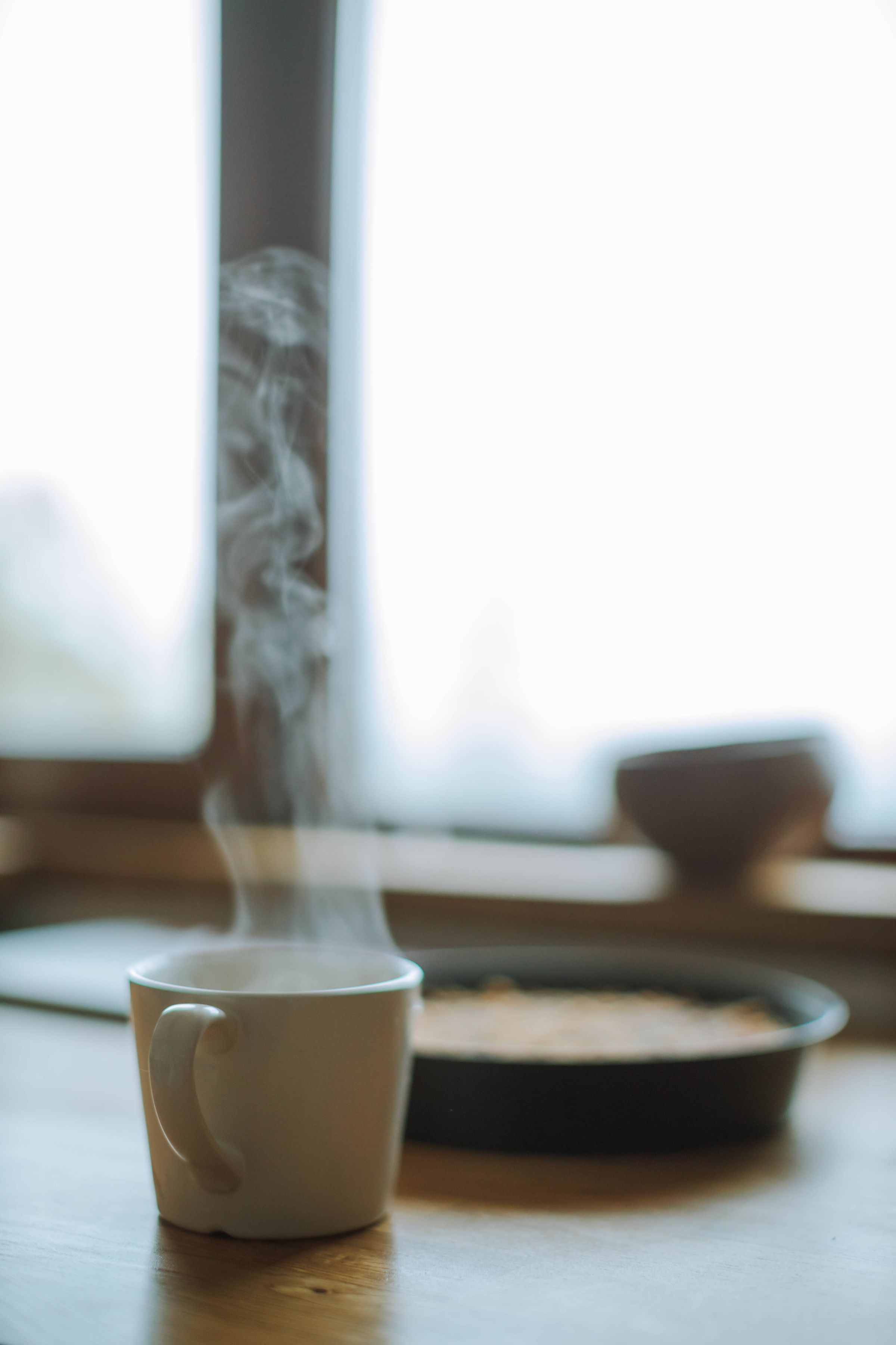 Steaming mug on a winter windowsill