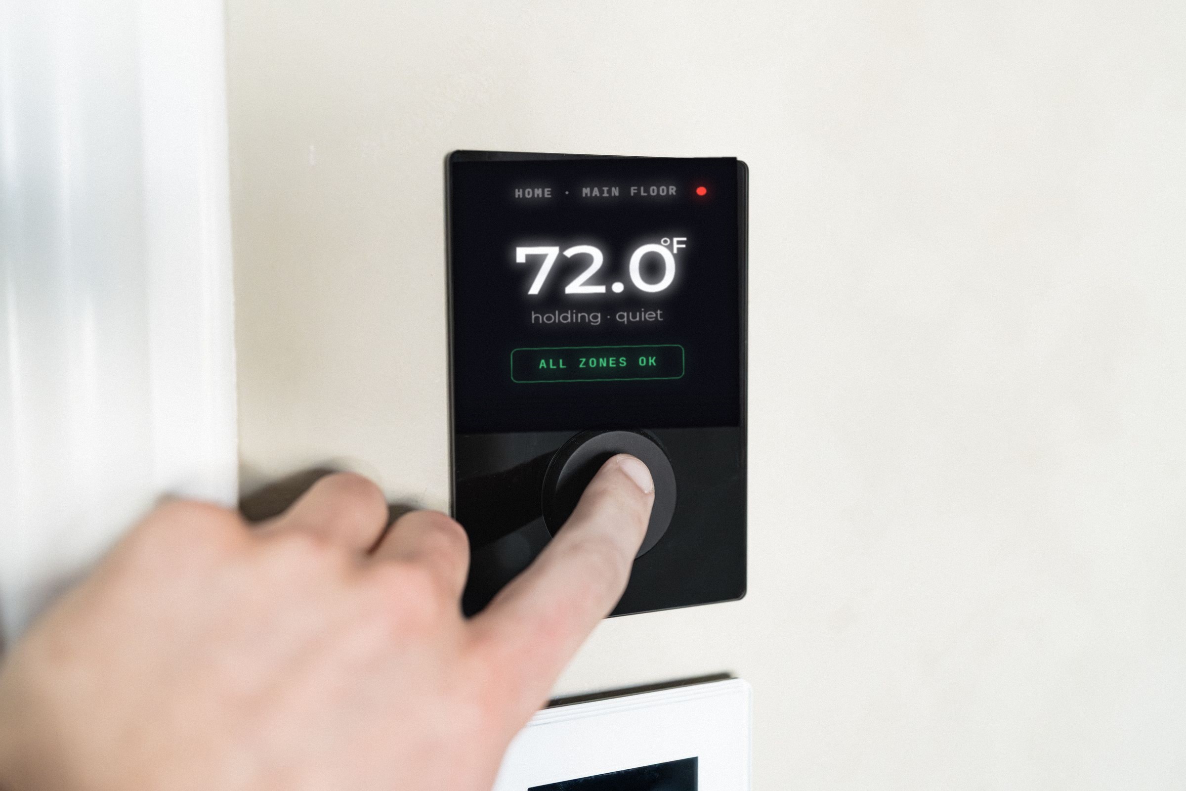 Finger on a wall-mounted control