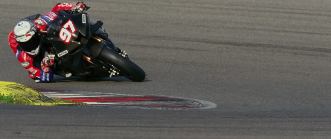 Superbike at full lean through an apex