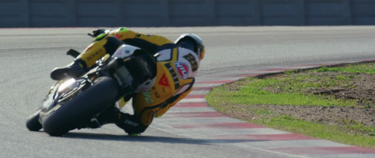 Motorcycle at full lean through a corner